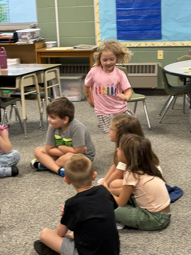 Student running while playing duck duck goose