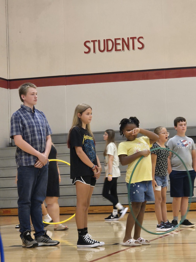 Students holding hula hoops waiting for instructions