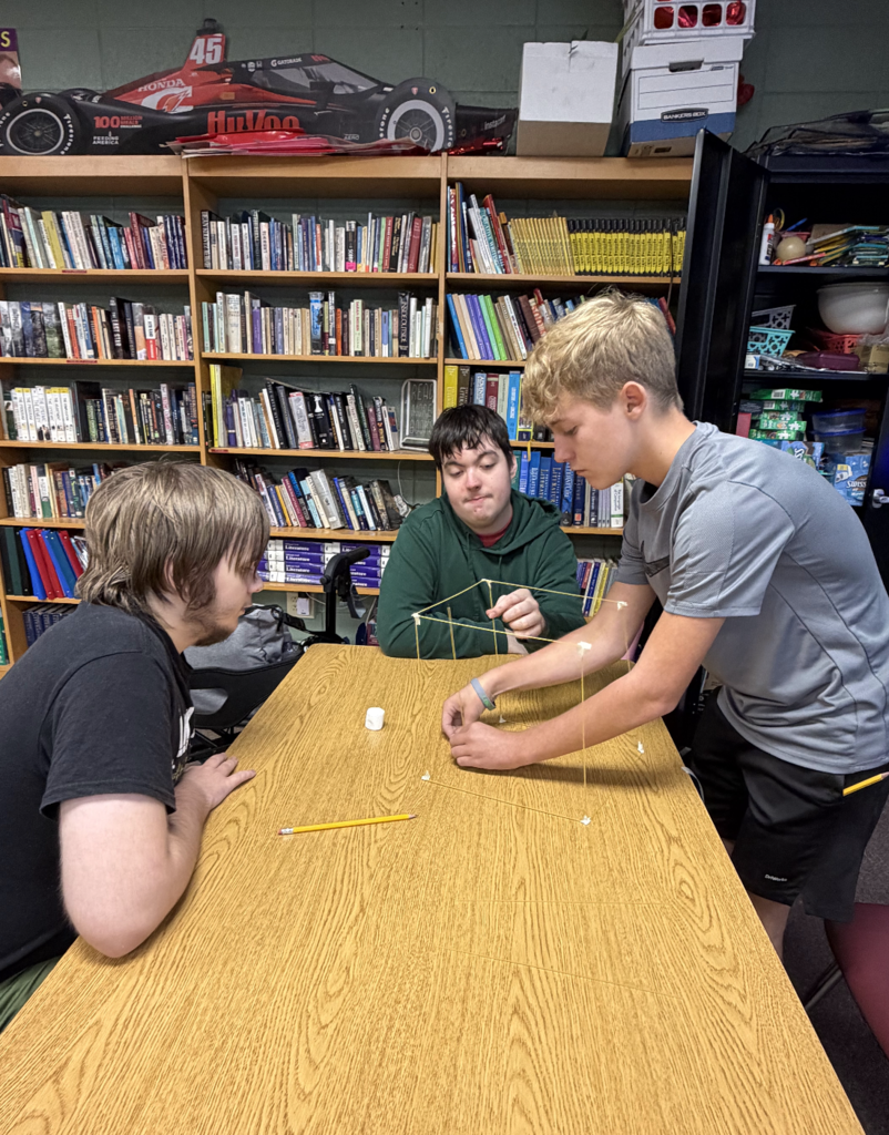 Three students building project together