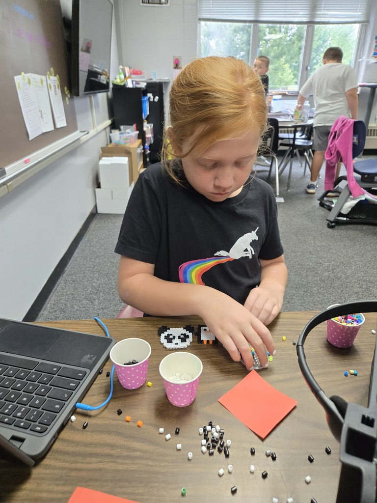 Student making a beaded panda