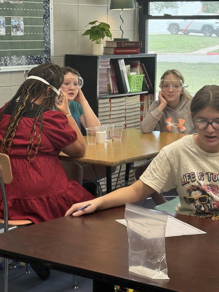 Students wearing goggles and working on a science experiment