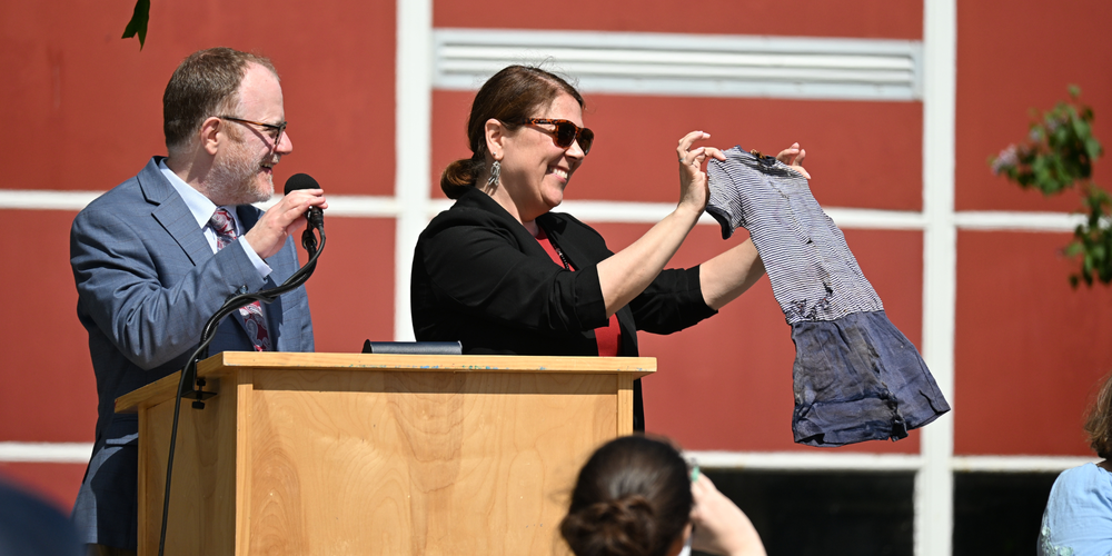 Principal Wood showing contents from the time capsule, including a gym uniform