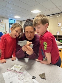 Teacher showing students a fossil