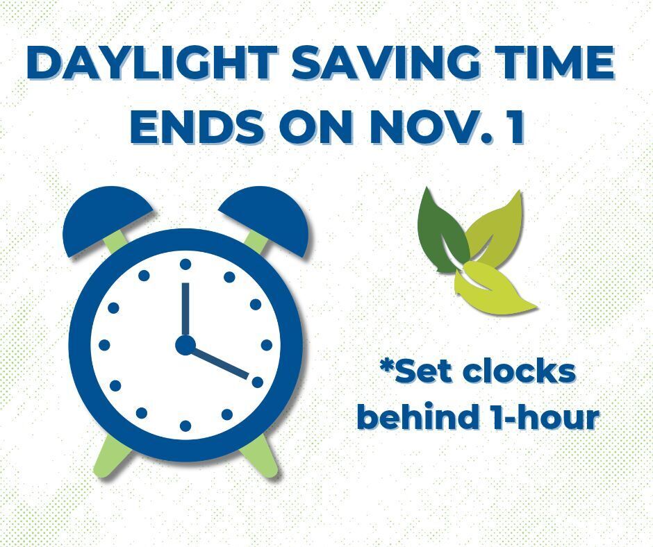 An alarm clock and a green leaf with a message that reads "Daylight Saving Time ends on Nov. 1. Set clocks behind 1-hour."