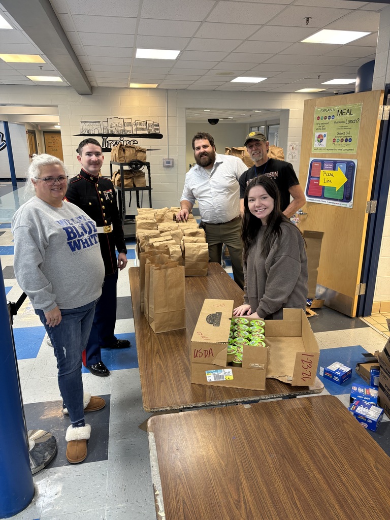 High School Staff Members (with help from their Marine Recruiter) getting food ready for their students!