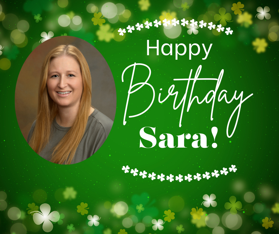 This flyer has a festive St. Patrick’s Day–inspired birthday theme with a vibrant green background. The backdrop features soft glowing light effects and scattered shamrocks in various shades of green and white, creating a whimsical, celebratory feel. Small white clover garlands frame the top and bottom of the design.  On the left side, there is a large oval-framed professional headshot of a smiling woman with long, straight red hair. She is wearing a simple gray top, and the portrait has a neutral studio-style background.  On the right side, bold white text reads:  Happy (in a clean, simple font) Birthday (in a large, elegant script font) Sara! (in bold serif lettering with an exclamation point)  The white lettering contrasts sharply against the rich green background, making the message stand out clearly. Overall, the flyer feels bright, cheerful, and personalized, blending a birthday celebration with a lucky shamrock theme. 🍀🎉