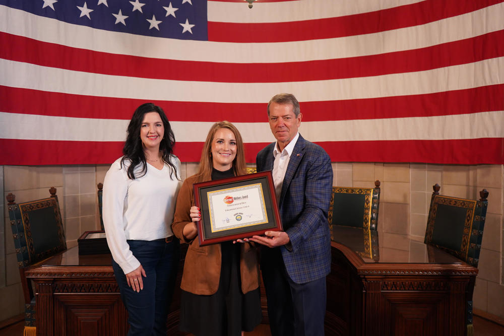 Nichole Hall and Sydney Bristol accepting award from Governor Jim Pillen