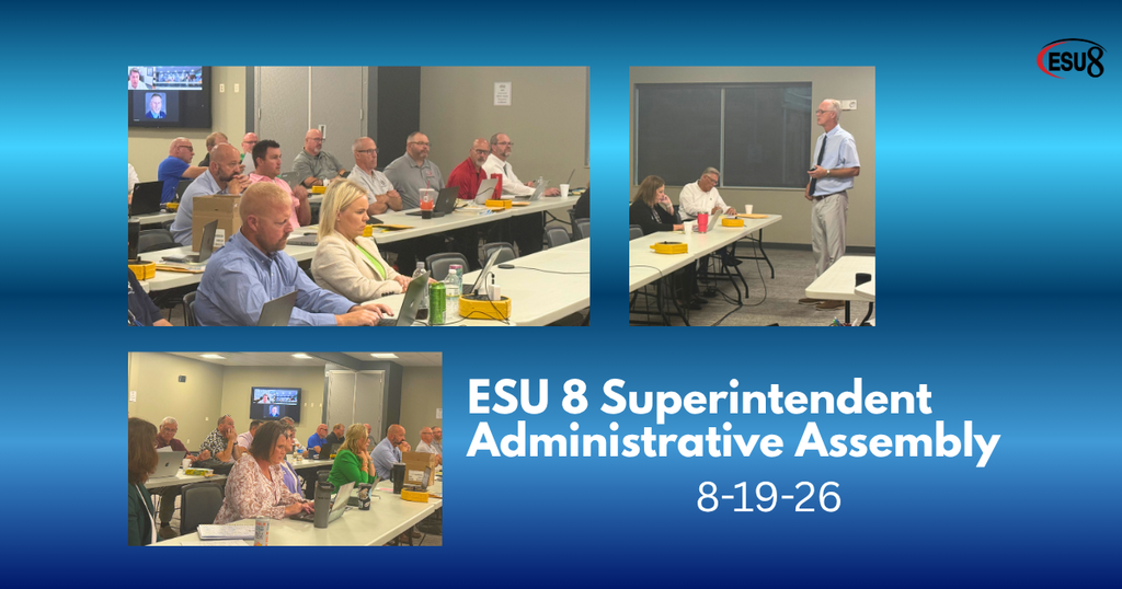 men and women from the ESU 8 sitting at long white tables in a conference room