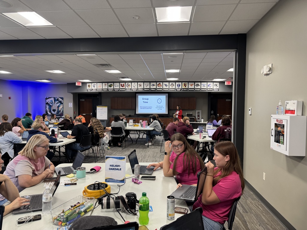 high school students sitting at white conference room tables