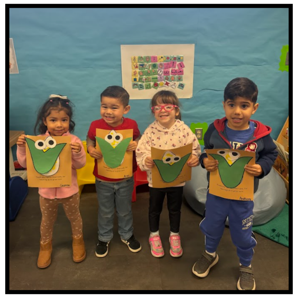 No text Image: four students holding a corn photo
