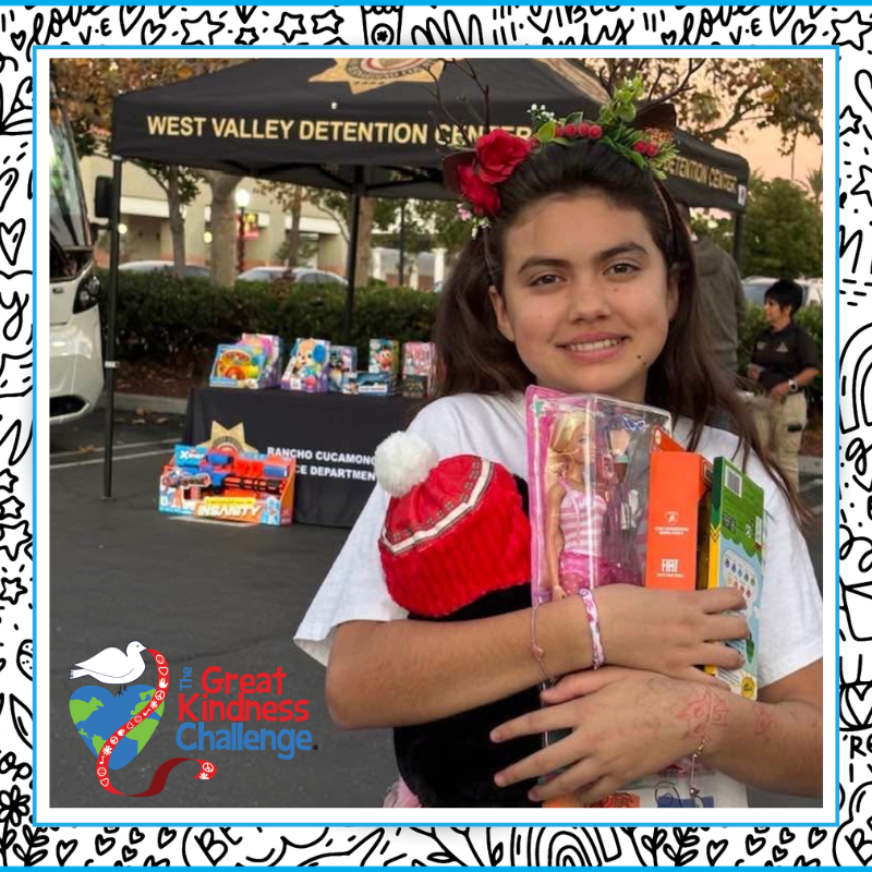 Text: Great Kindness Challenge Image: student holding toys.