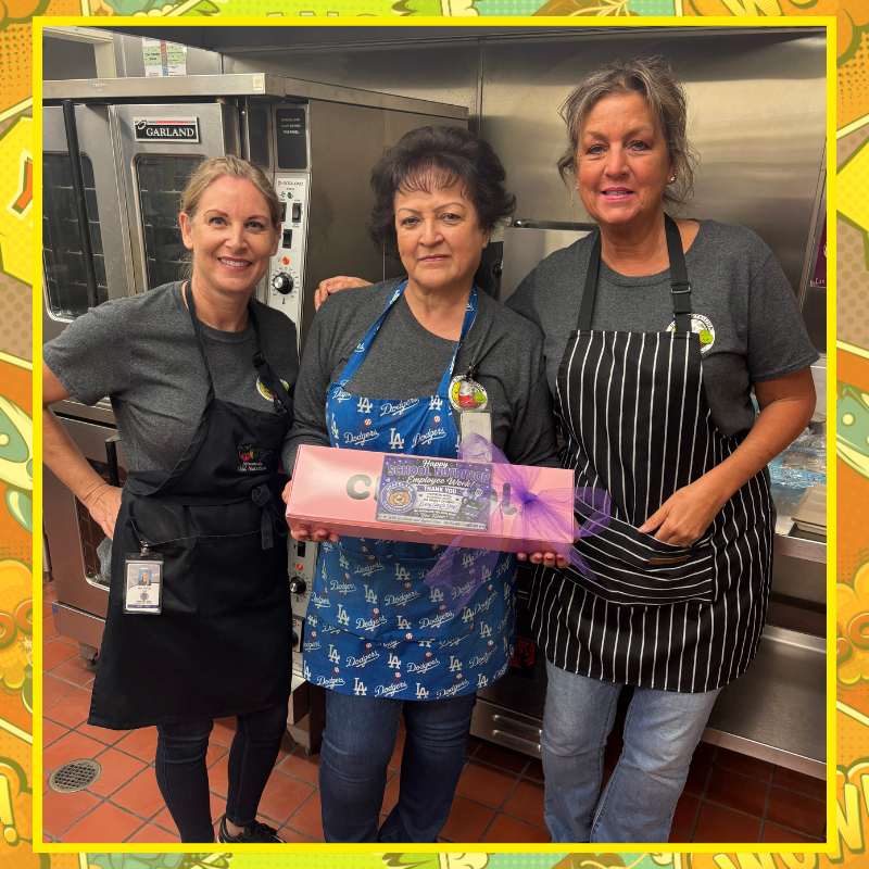 No text Image: three smiling females in a kitchen