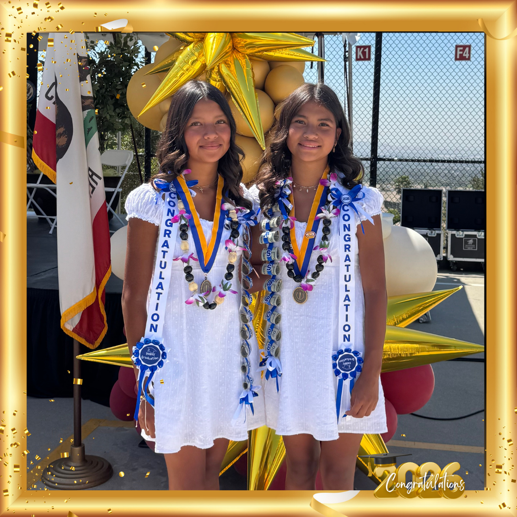 No Text: image of two smiling students wearing white