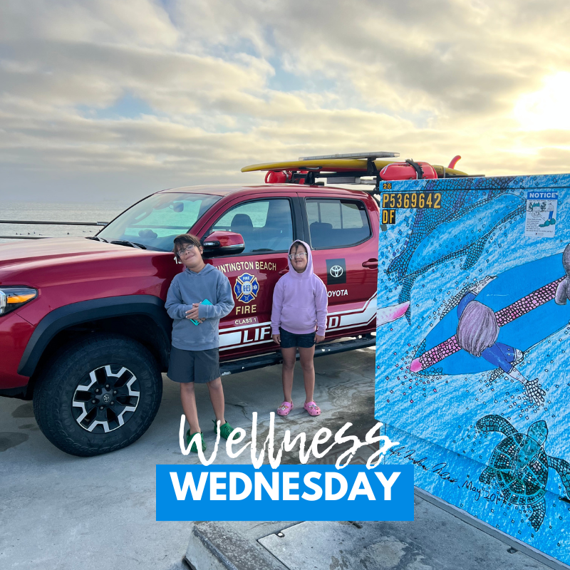 Text: wellness wednesday Image: two kids in beach clothes by a car