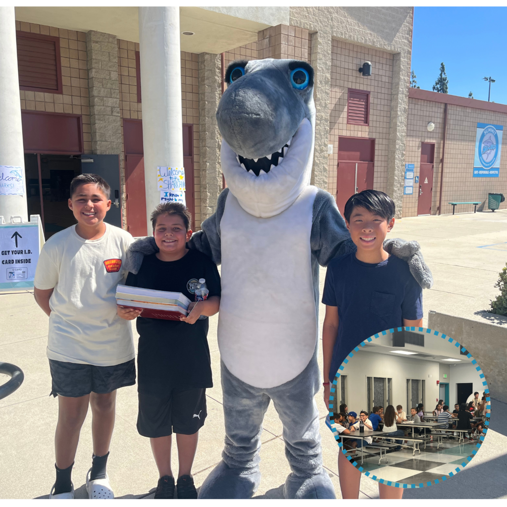No text Image: students smiling with shark mascot and a cafeteria filled with students