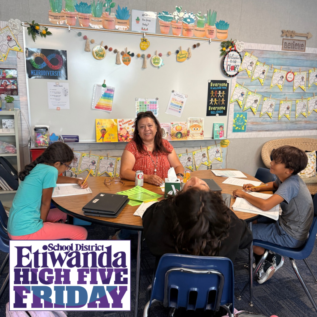Text: High Five Friday Image: female in an orange shirt sitting around a table