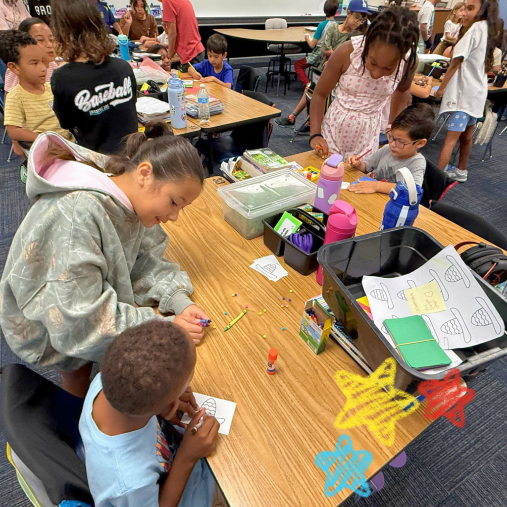 No text Image: 5th grade students working with Kinder students