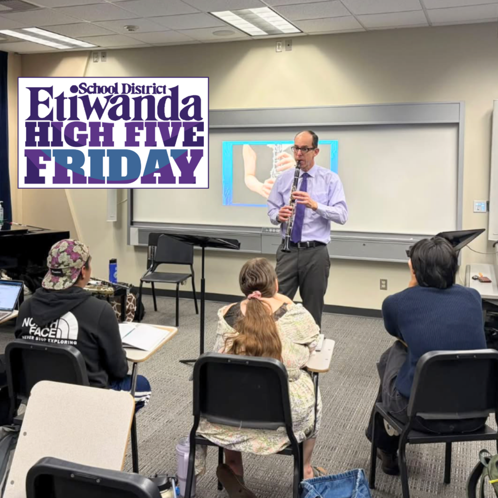 Text: Etiwanda High Five Image: Man standing in a classroom with a instrument teaching a class