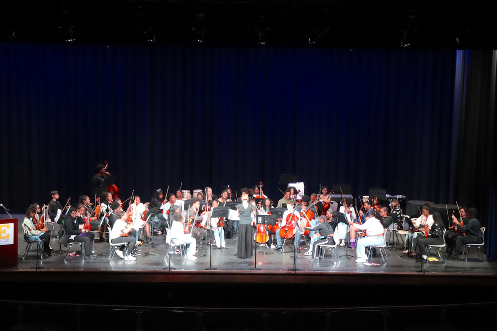 Euclid Middle School Orchestra on stage with their instruments