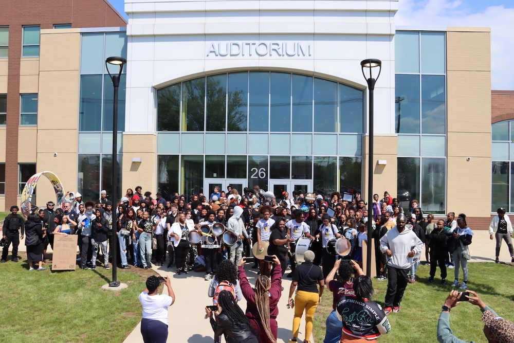 The Class of 2026 standing outside Euclid High School posing for a group photo after the Senior Clap Out.