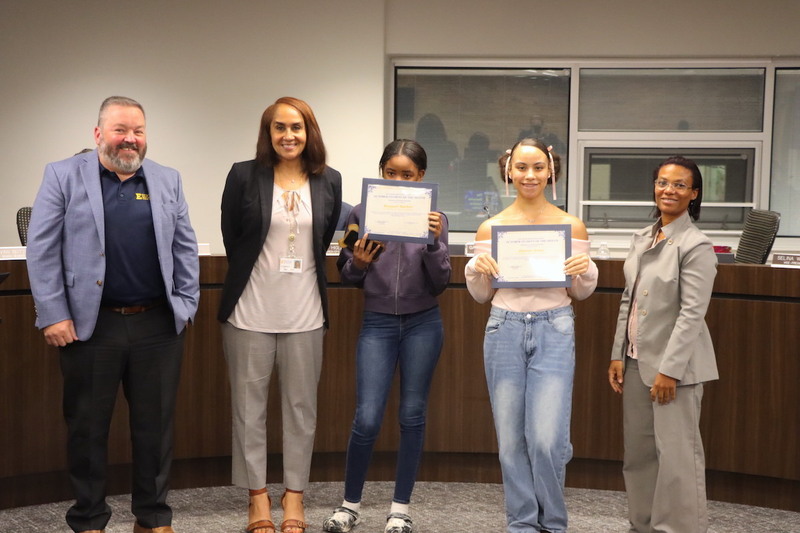 Memorial Options Center Principal Jason Coleman, Superintendent Karen Brown accompanied by two Memorial Options Center Students and Board President Gabrielle Kelly.