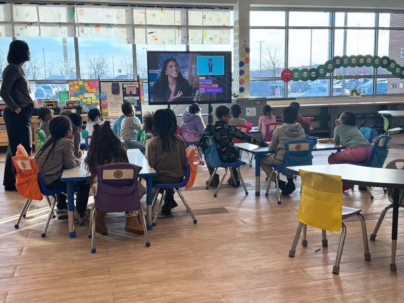 Students watching a video about coding.