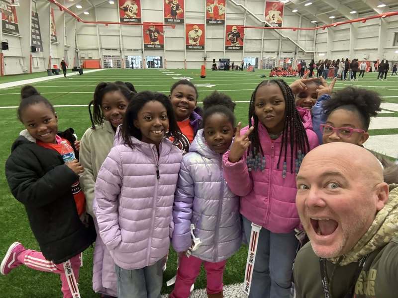 Euclid Girls and Assistant Principal posing for a photo at the Browns Facility