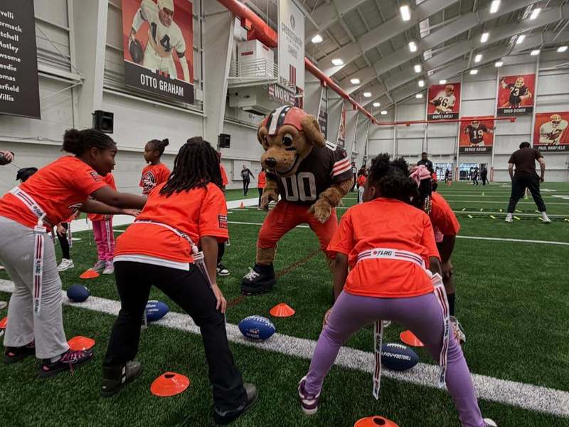 Girls going through a drill with Chomps the Browns mascot