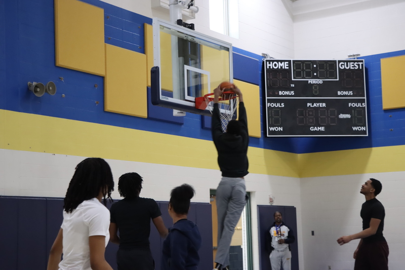 EHS Basketball Player Kye Owens dunking a basketball.