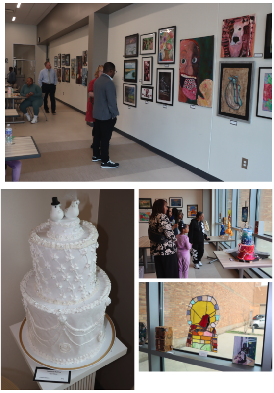 People reviewing artwork in the Bistro. A wedding cake. 3-D designs. Stained Glass design hanging in the window.
