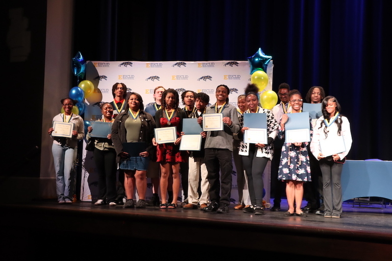 Honors Scholars posing with their certificates and graduation medals.