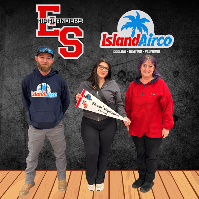 student posing with pennant