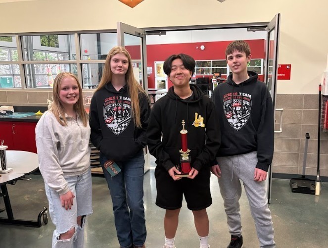 students posing for chess