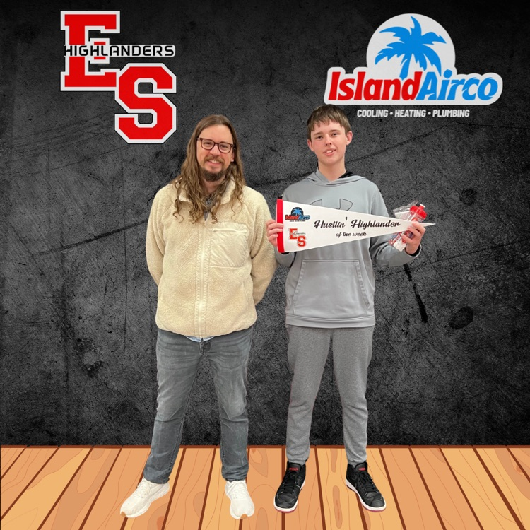 student and teacher posing. with pennant