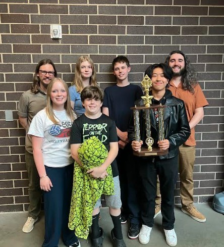 students pose with trophy