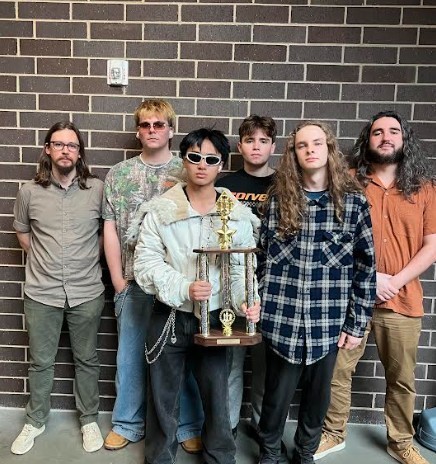 students pose with trophy