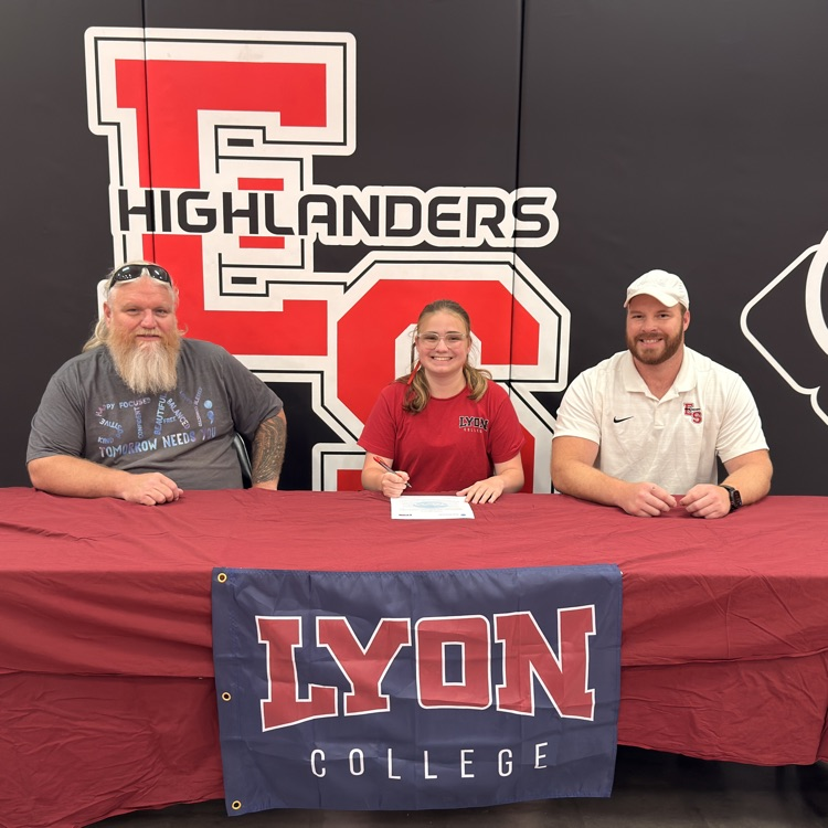 student signing at table