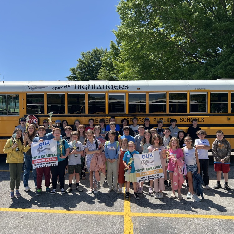 students in front of a bus