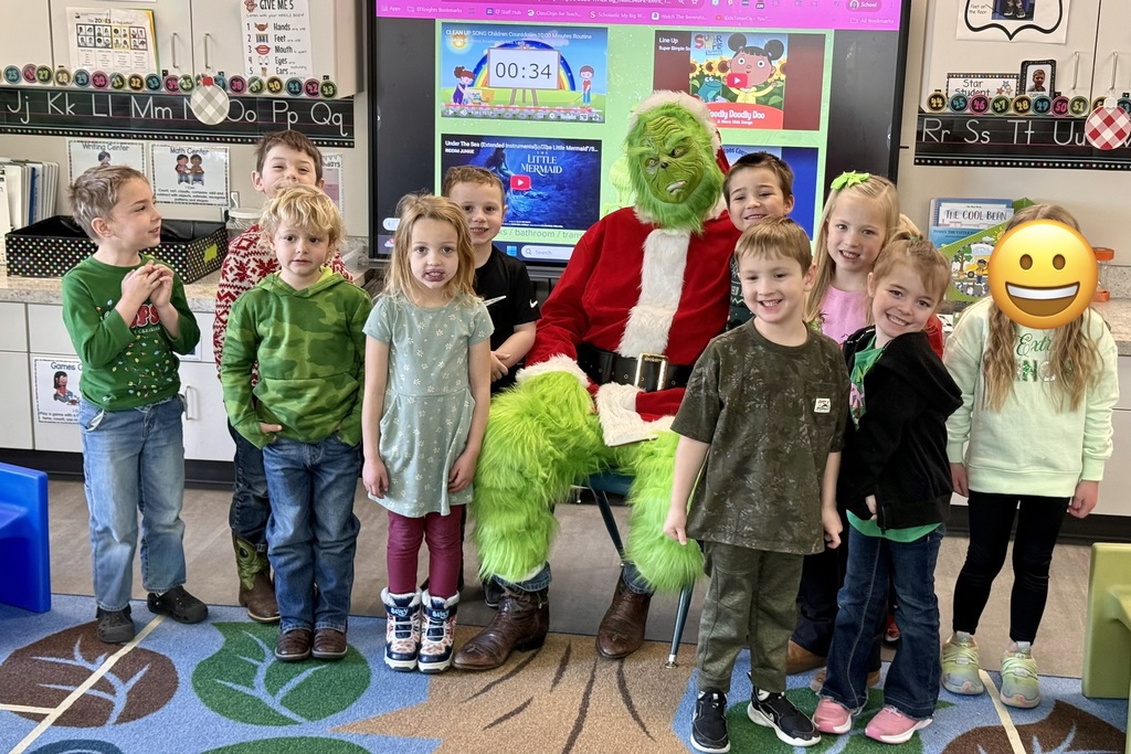 PreK students posing with the Grinch