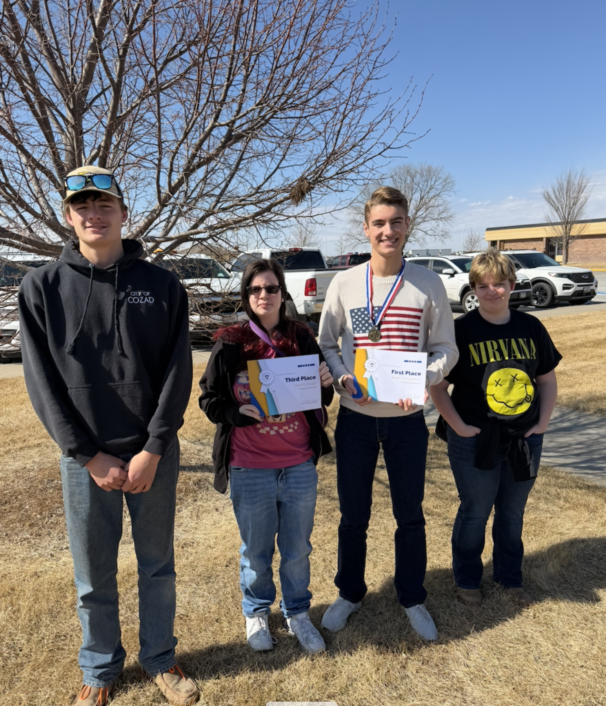 Students participating in InterHigh Day. Two holding their award certificates.