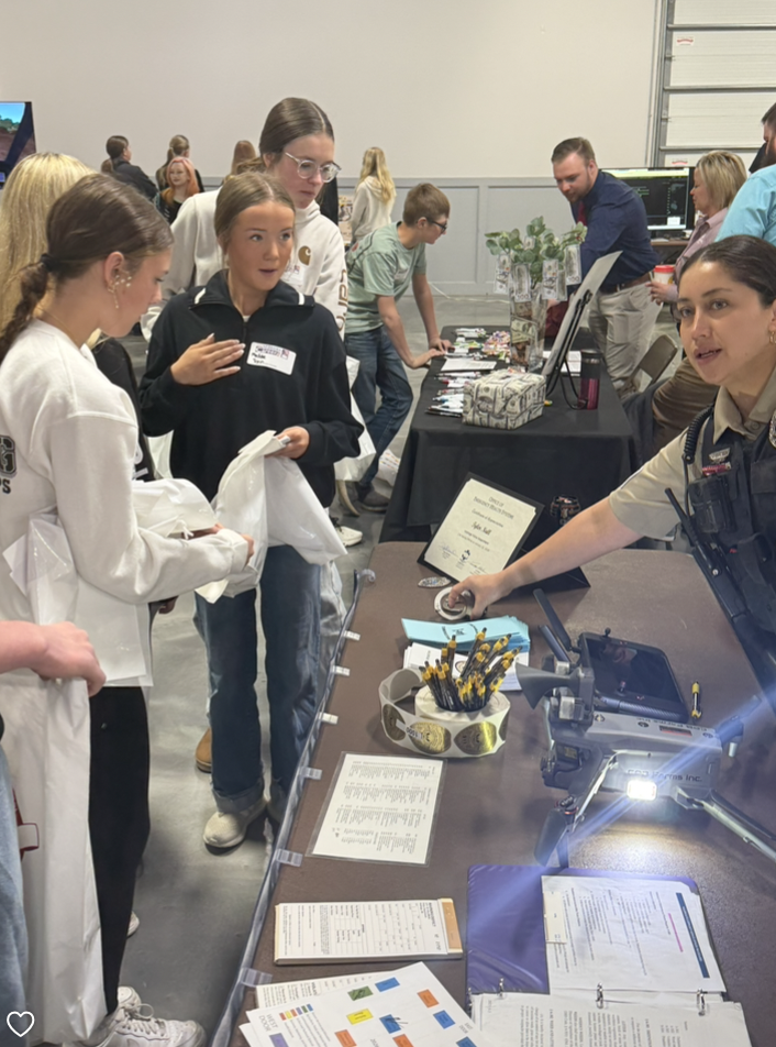 girls standing by table