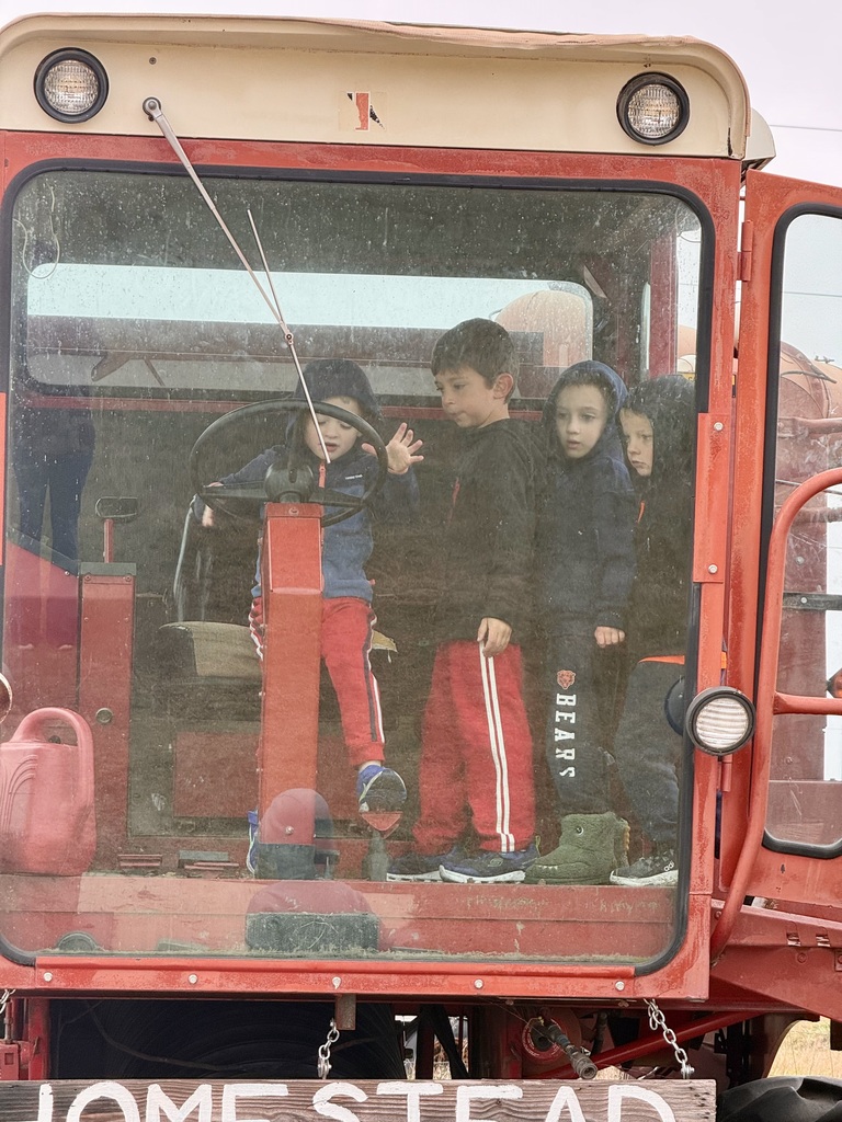 Boys pretending to drive a combine
