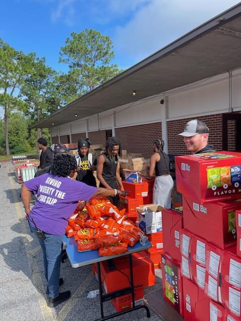 Students loading food bank items