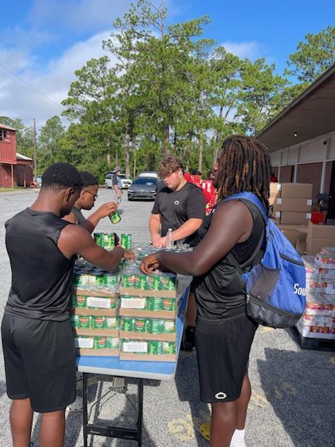 Students loading food bank items