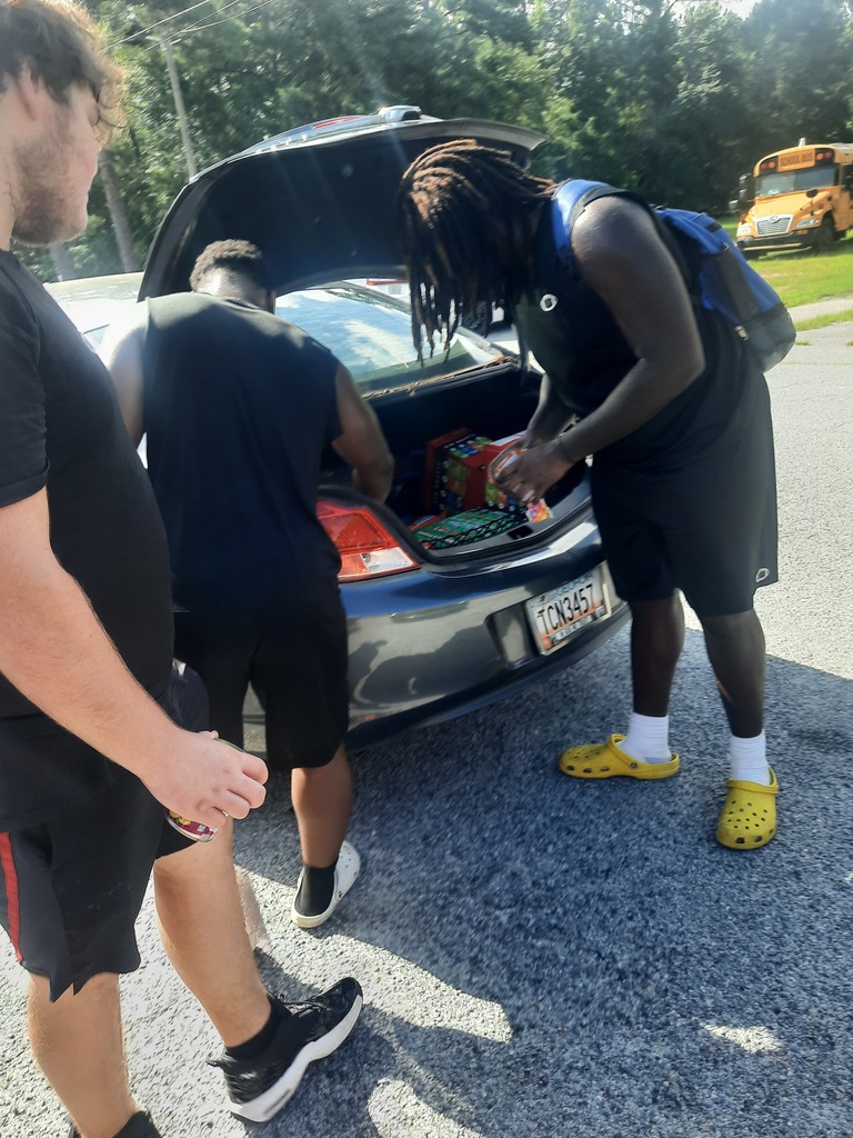 Students loading food bank items