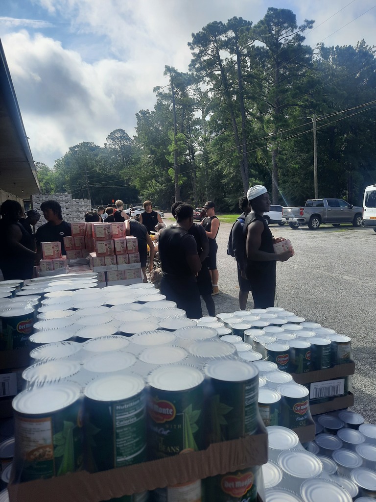 Students loading food bank items