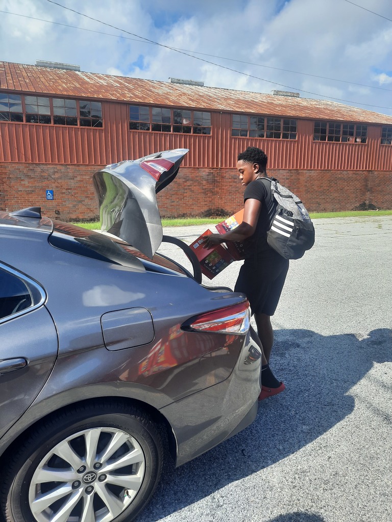 Students loading food bank items