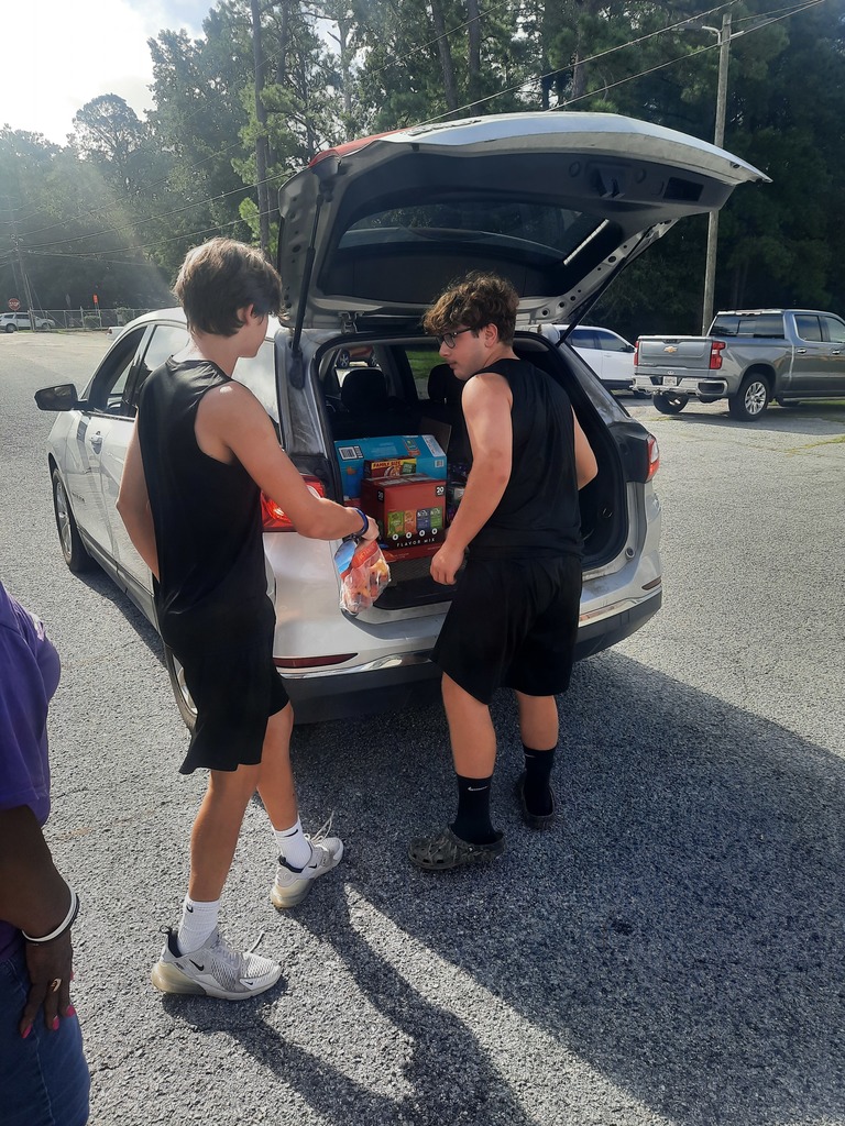 Students loading food bank items