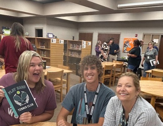 Teachers sitting at table and beginning welcome back meetings