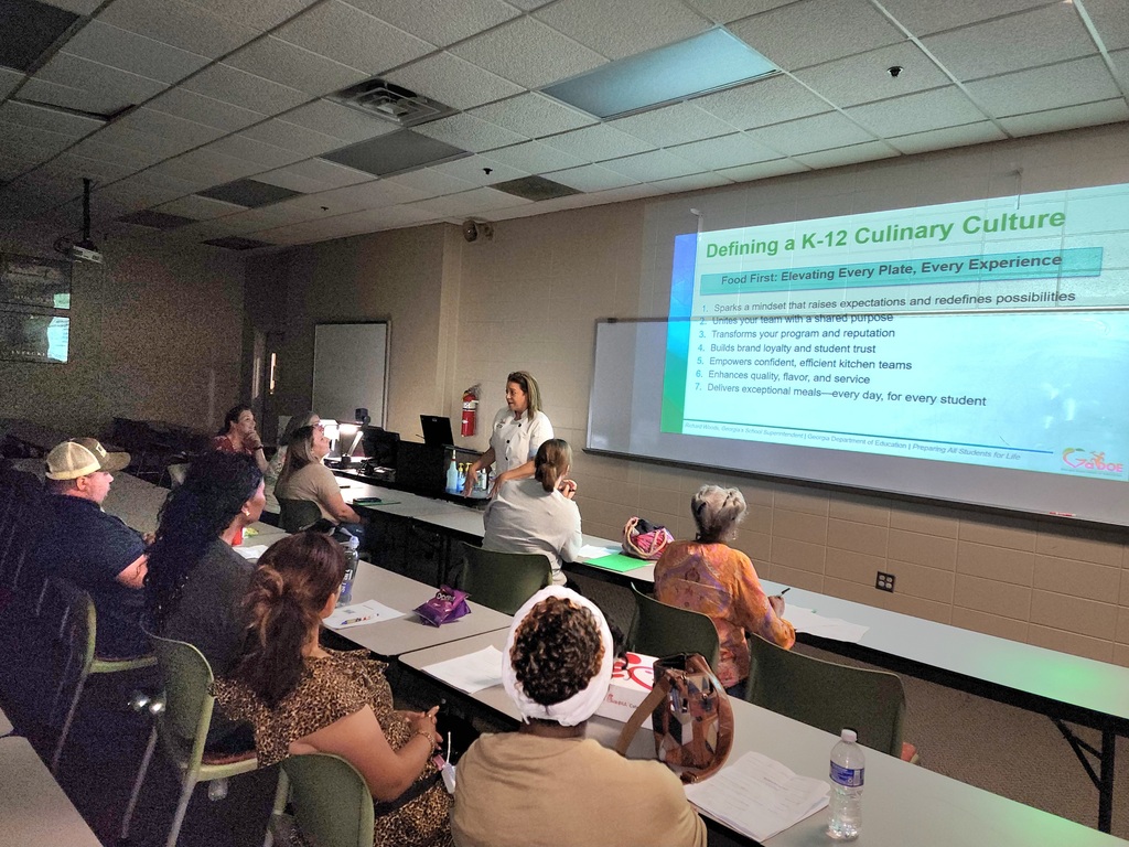 Employees learning from Chef Rachel about defining a K-12 Culinary Culture